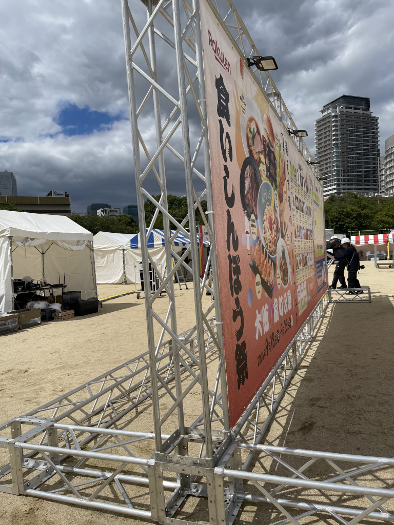 屋外イベントに設置したトラスと大型バナー